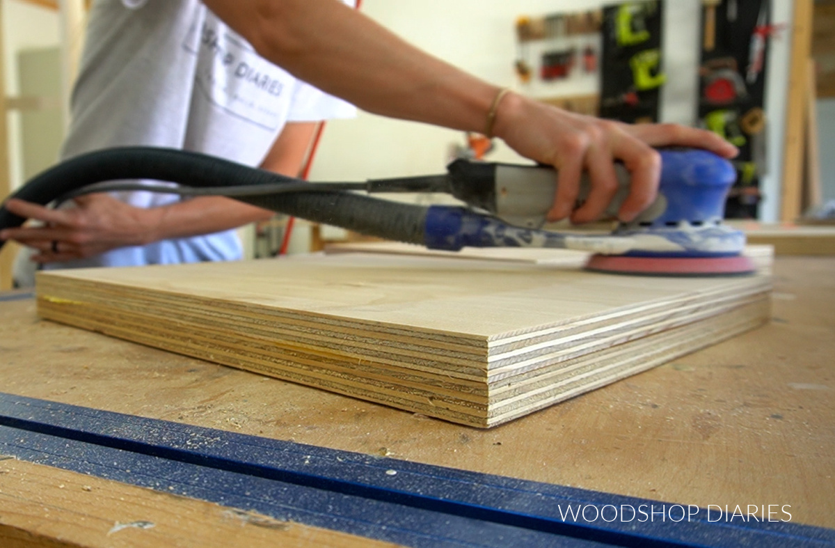 Close up of sanding bench seat supports on workbench