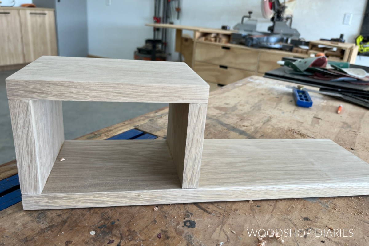 Wooden tea tray with box on end of board made from oak wood on workbench