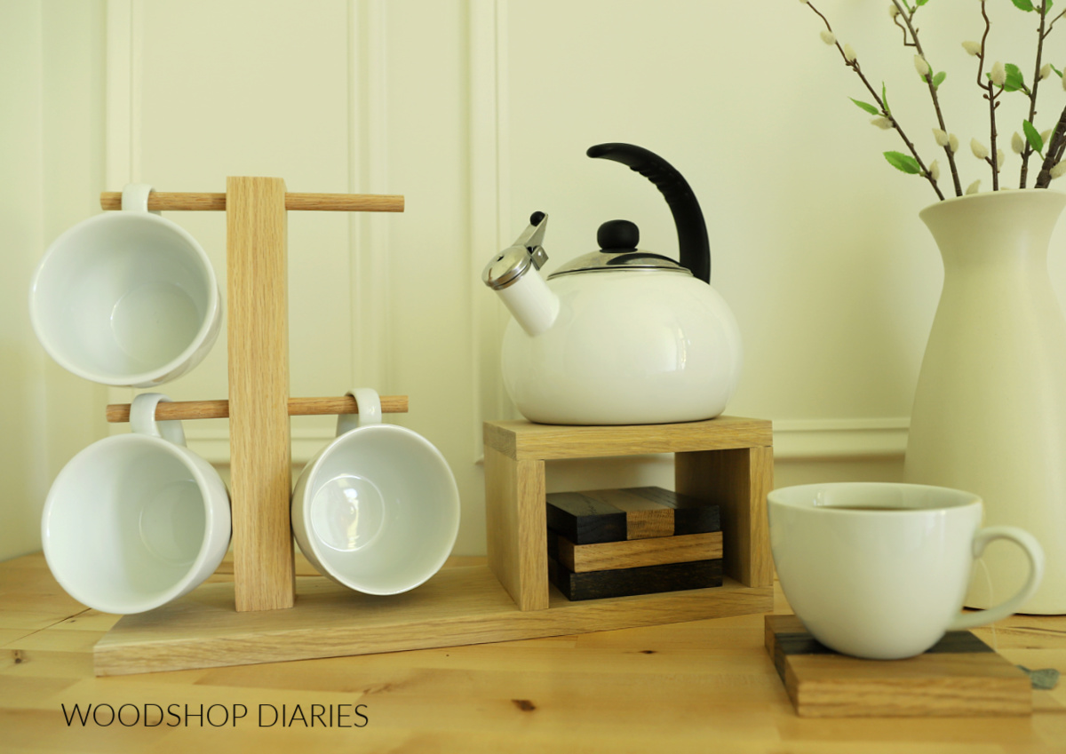 Wooden tea station tray with coaster storage underneath tea kettle platform with mug holder post made from oak scraps