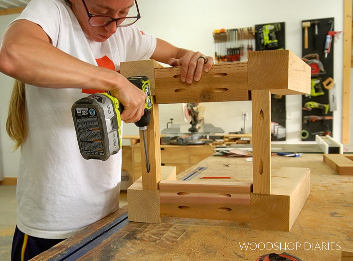 Shara Woodshop Diaries assembling outdoor side table frame on workbench with 2x4s and 2x2s