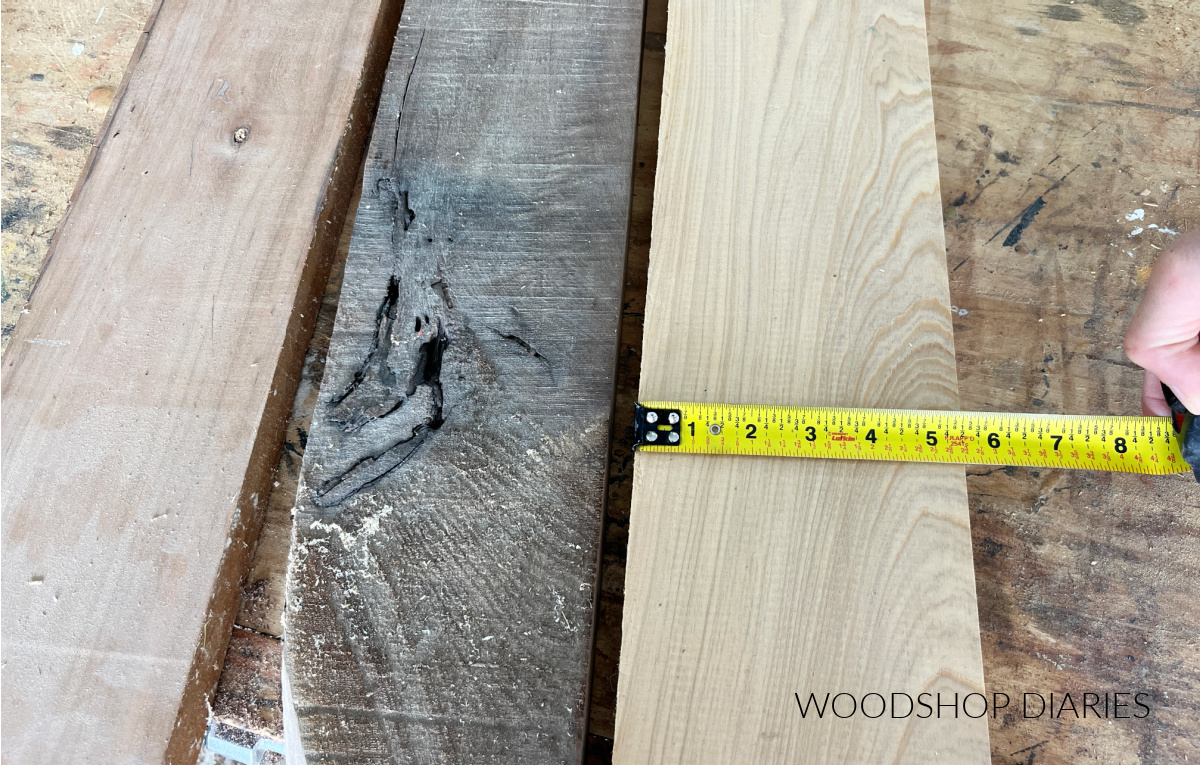Cherry, walnut, and cypress wood on workbench with tape measure showing the width