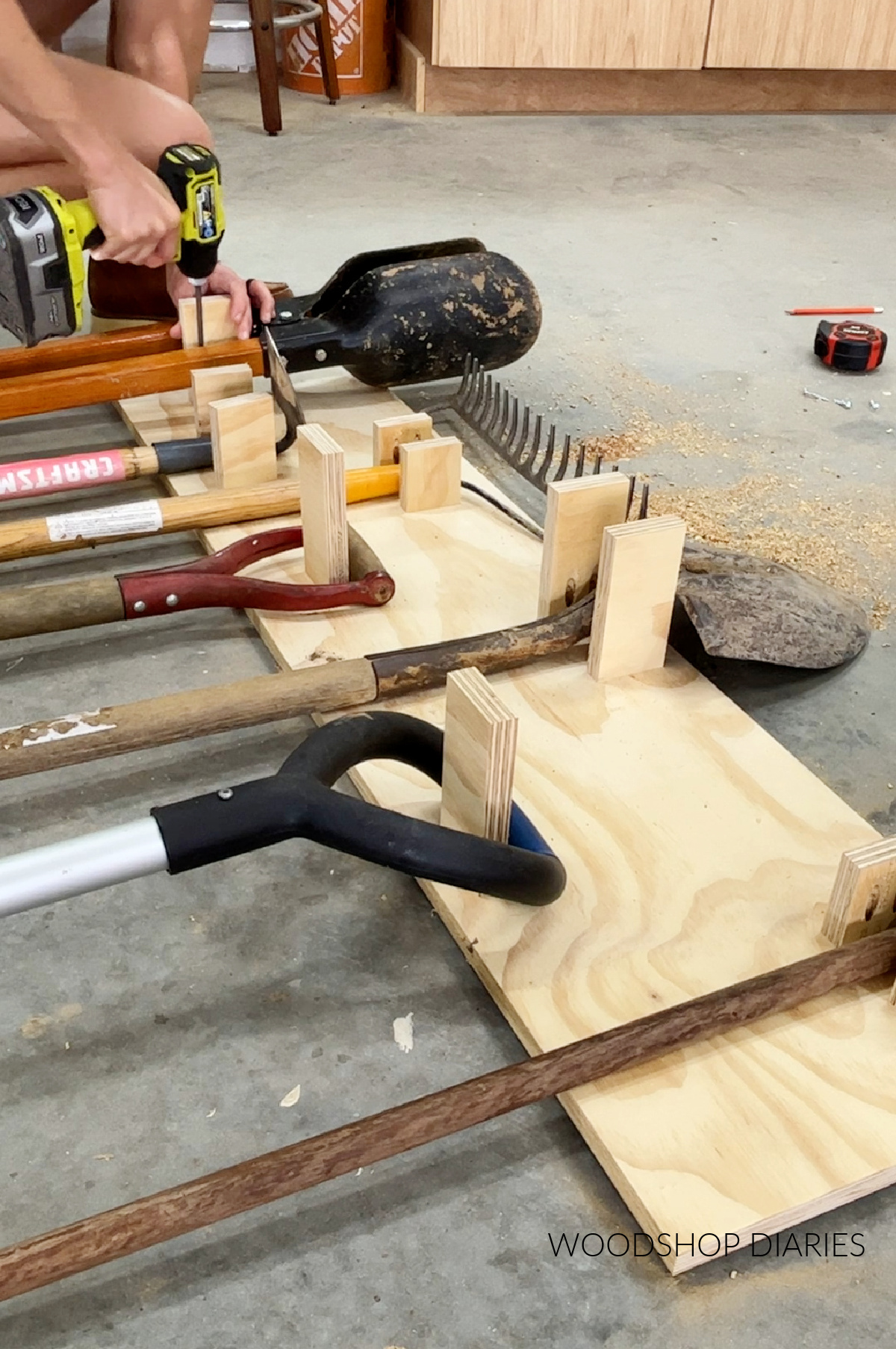 Installing yard tool hangers onto organizer back panel using pocket hole screws