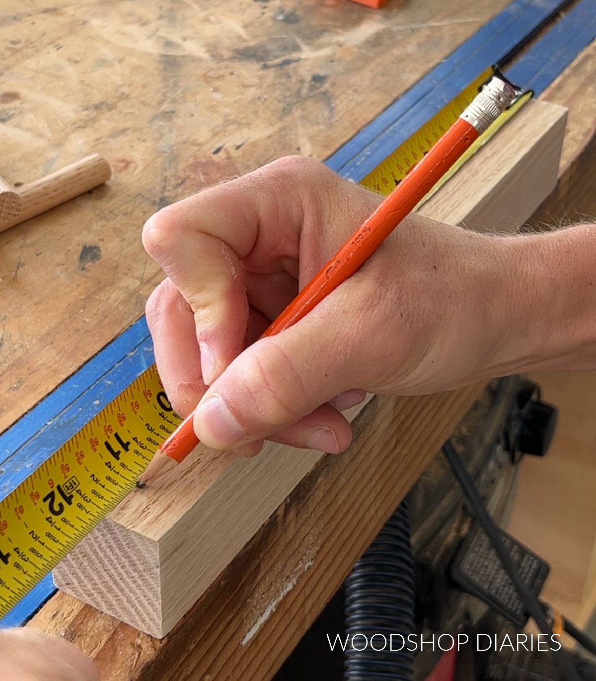 Marking 11 ¼" from bottom edge of board with pencil