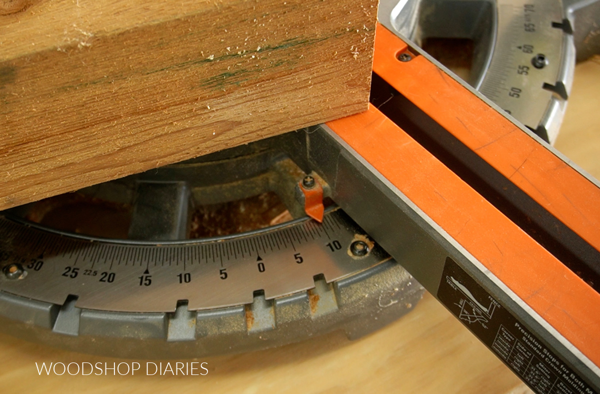 Close up of miter saw miter angle set to 10 degrees with board end cut on base