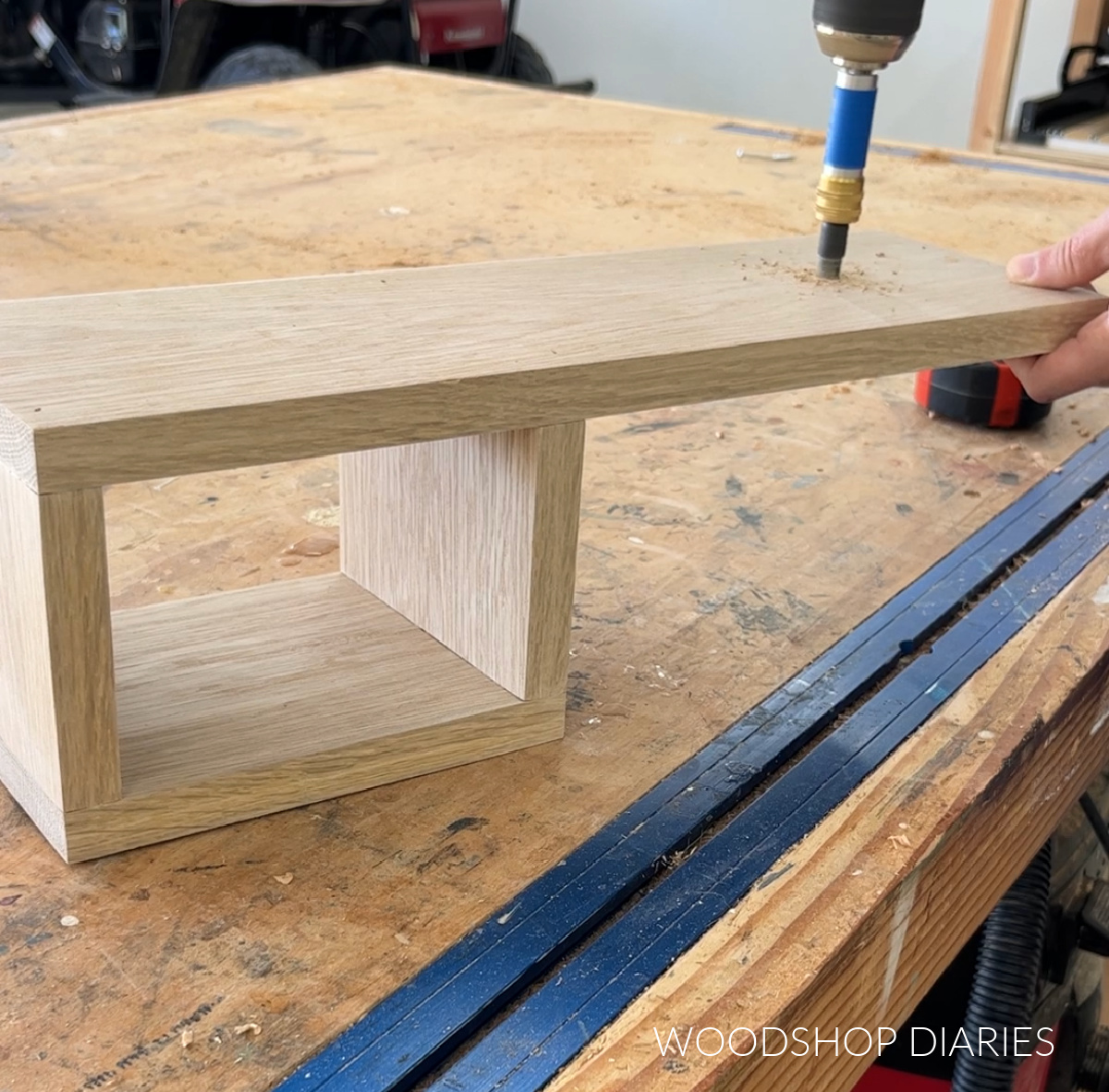 Predrilling holes into end of bottom of tea station tray