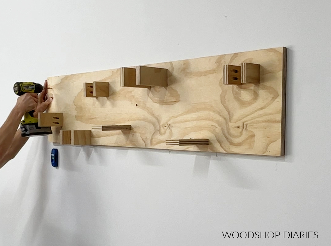 Installing yard tool organizer on wall into studs with wood screws