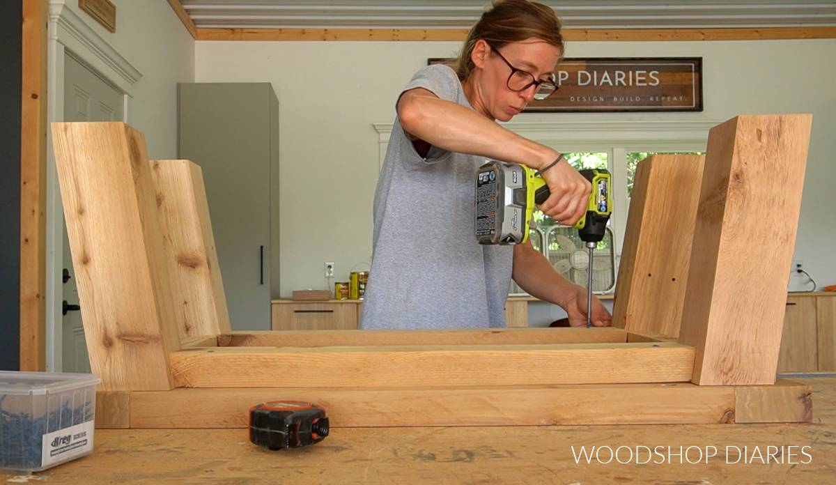 Shara Woodshop Diaries attaching coffee table base to top frame on workbench