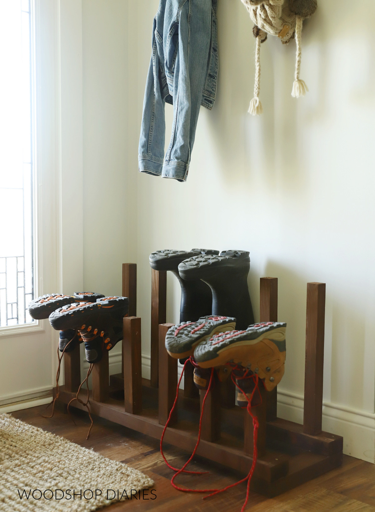 Wood stained DIY boot rack with 2x2 posts to place boots on--next to front door on floor