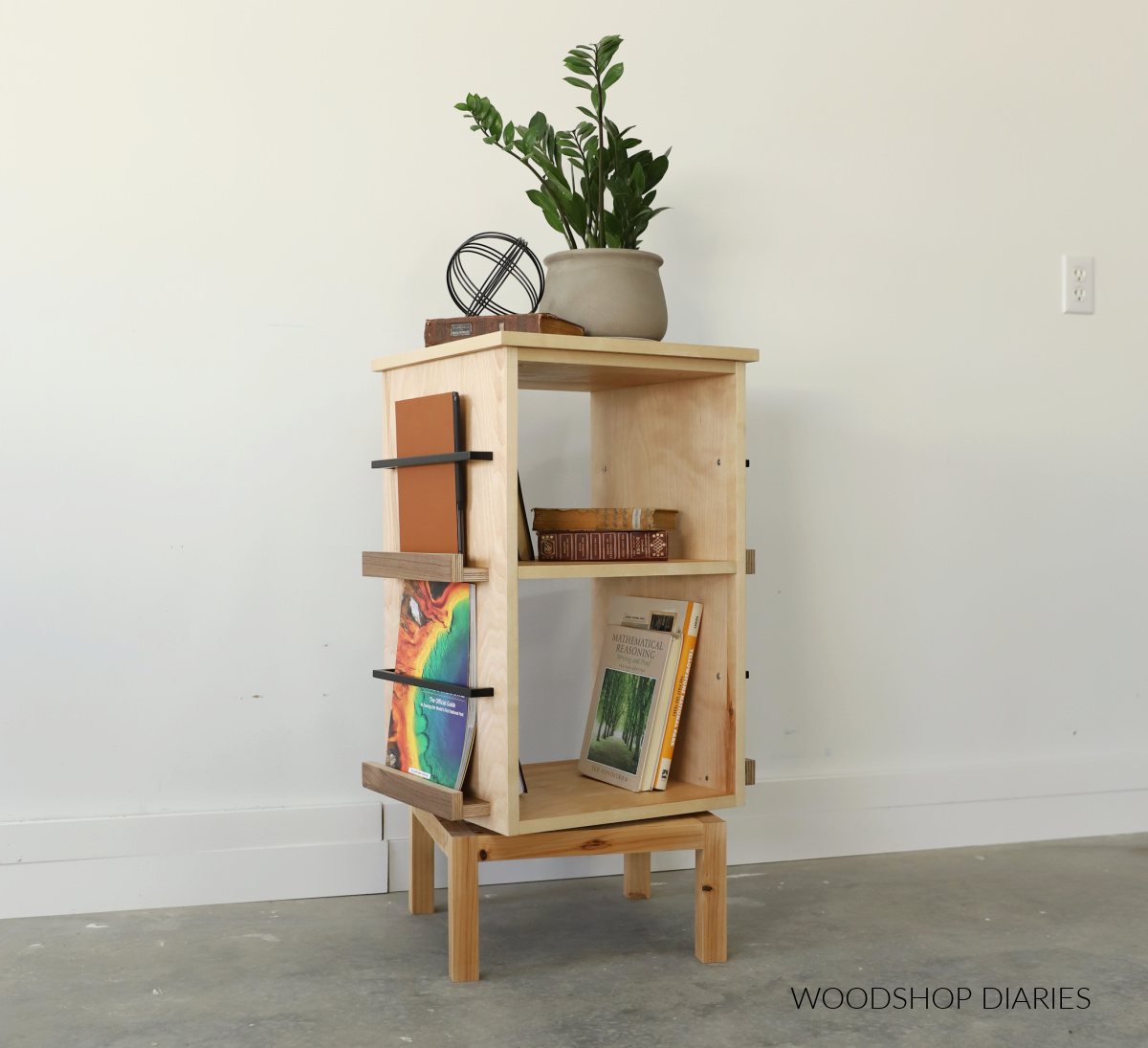 4 sided rotating bookshelf with magazine ledges on sides and open cubbies in center