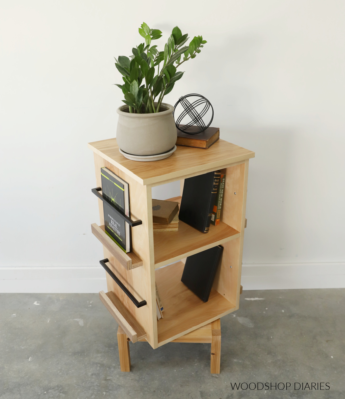 DIY Rotating bookshelf assembled with plywood--open cubbies in the middle with book ledges on the sides