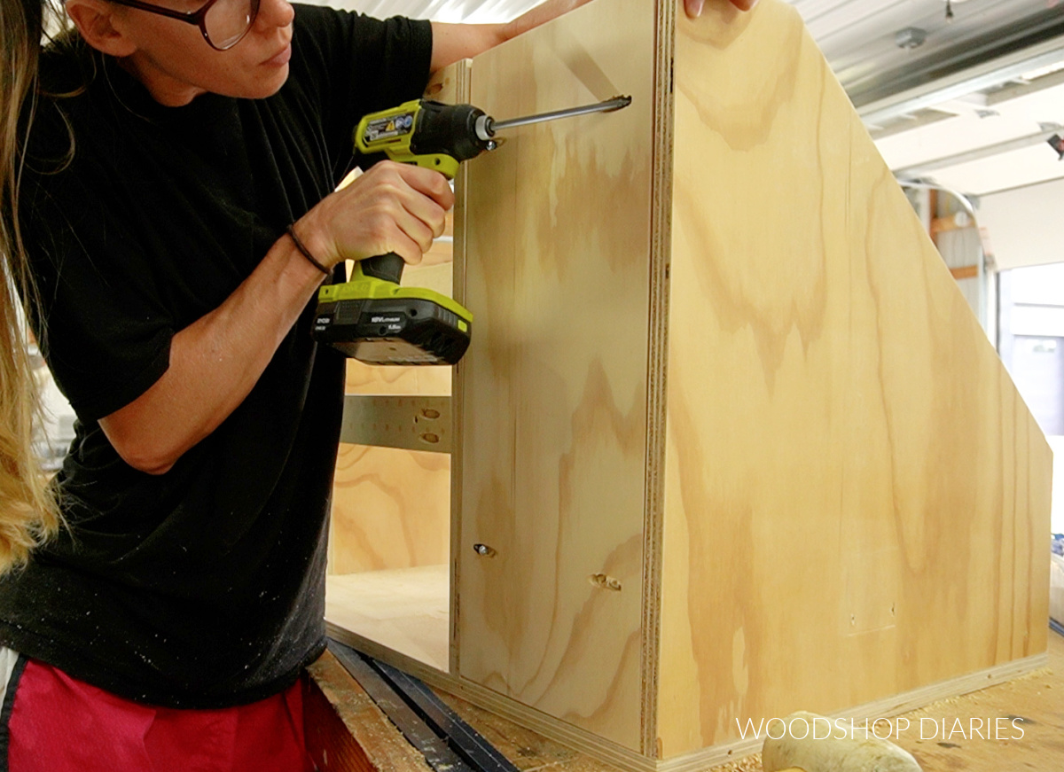 Installing solid back plywood panel into scrap wood cart assembly