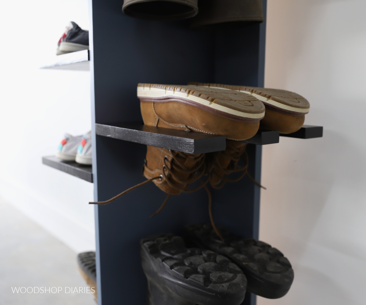 Close up of boots hanging upside down in slotted shelves on shoe shelf organizer