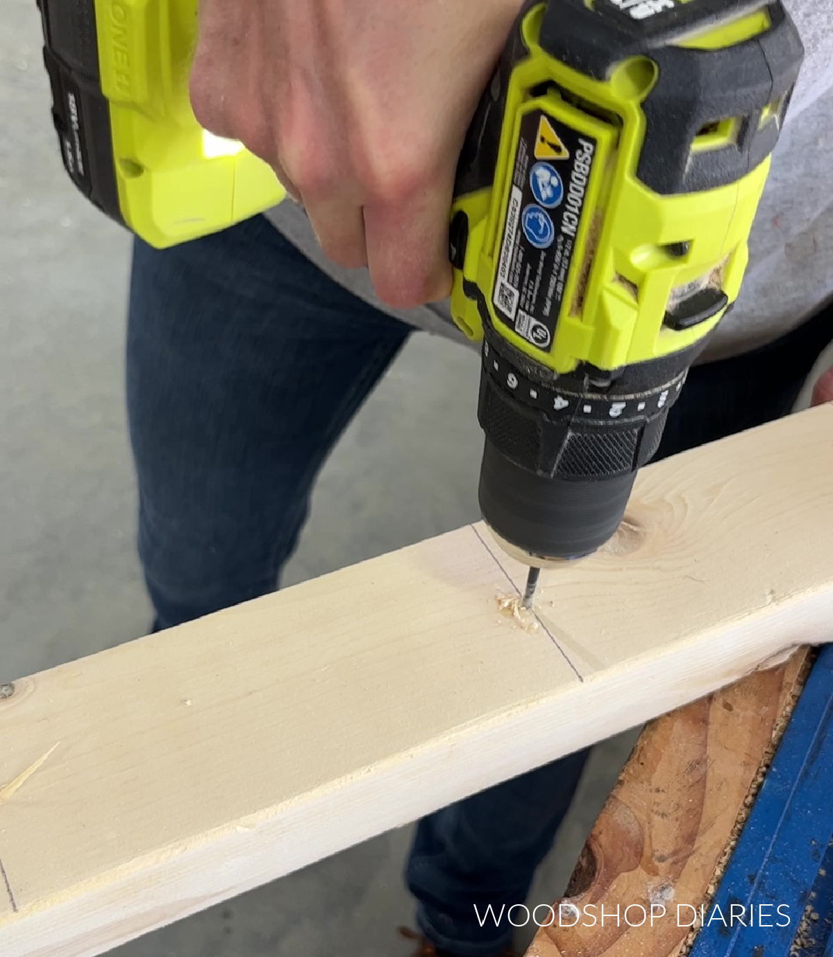 Using a drill to predrill pilot holes for boot rack posts