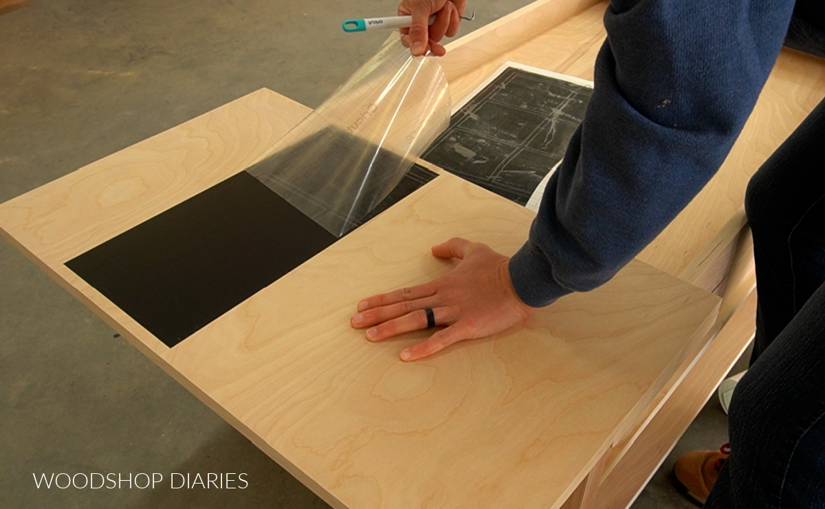 Removing transfer tape from tic tac toe stencil on coffee table flip top