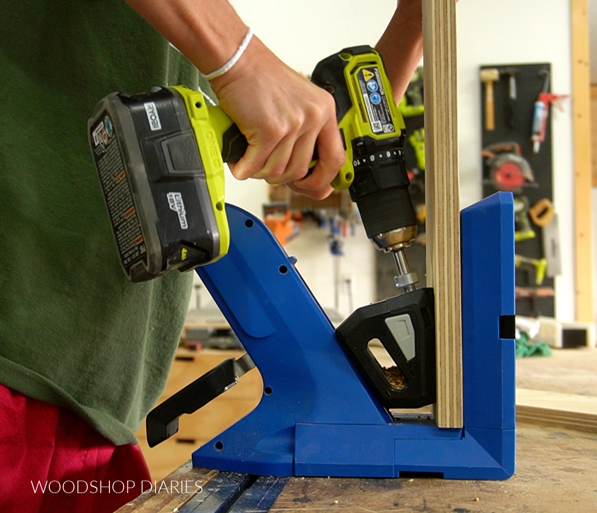 Close up of drilling pocket holes into plywood using Kreg 720 jig