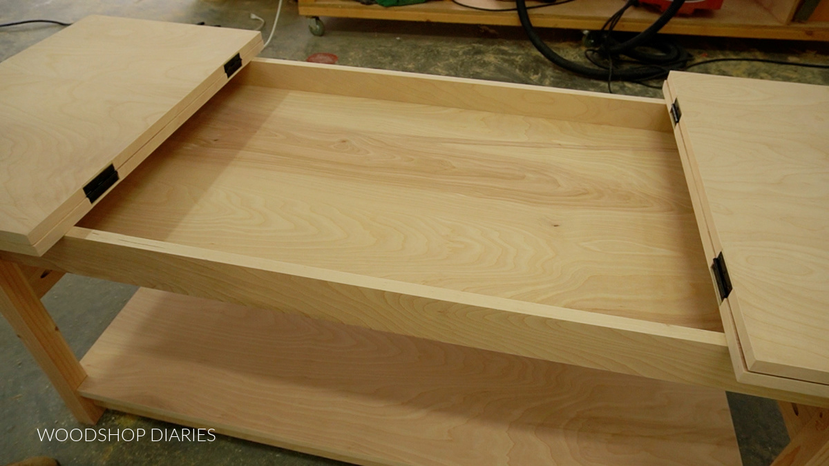 Flip tops of puzzle table open to reveal shallow top compartment