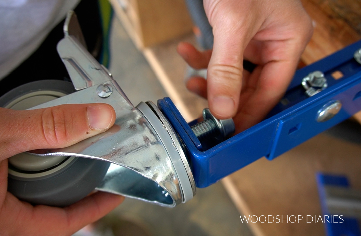 Close up of installing caster wheels on workbench legs with nut