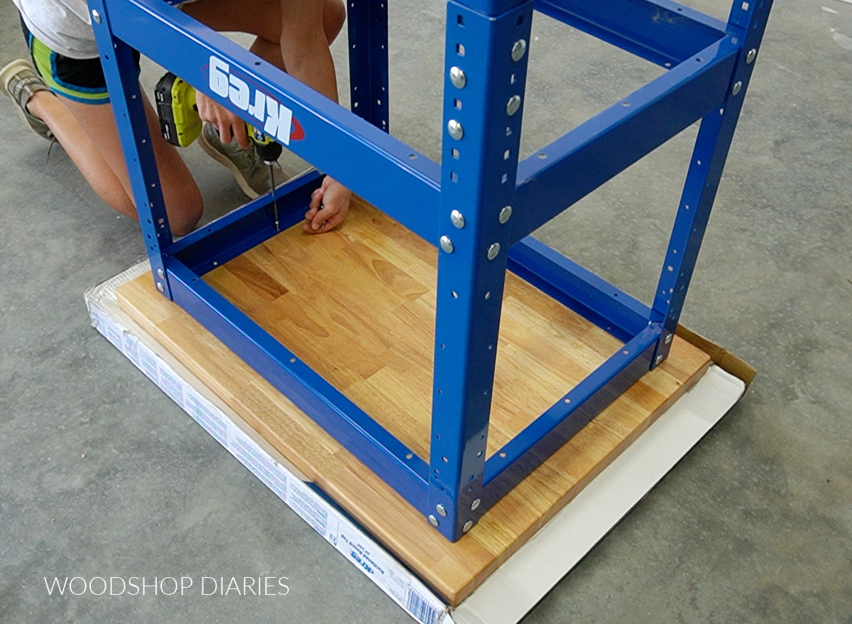 Shara Woodshop Diaries installing hardwood work top onto metal workbench frame