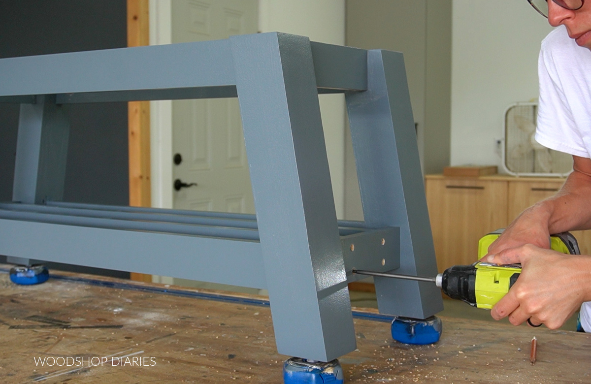 Driving screws to install shoe rails on bottom shoe shelf of bench