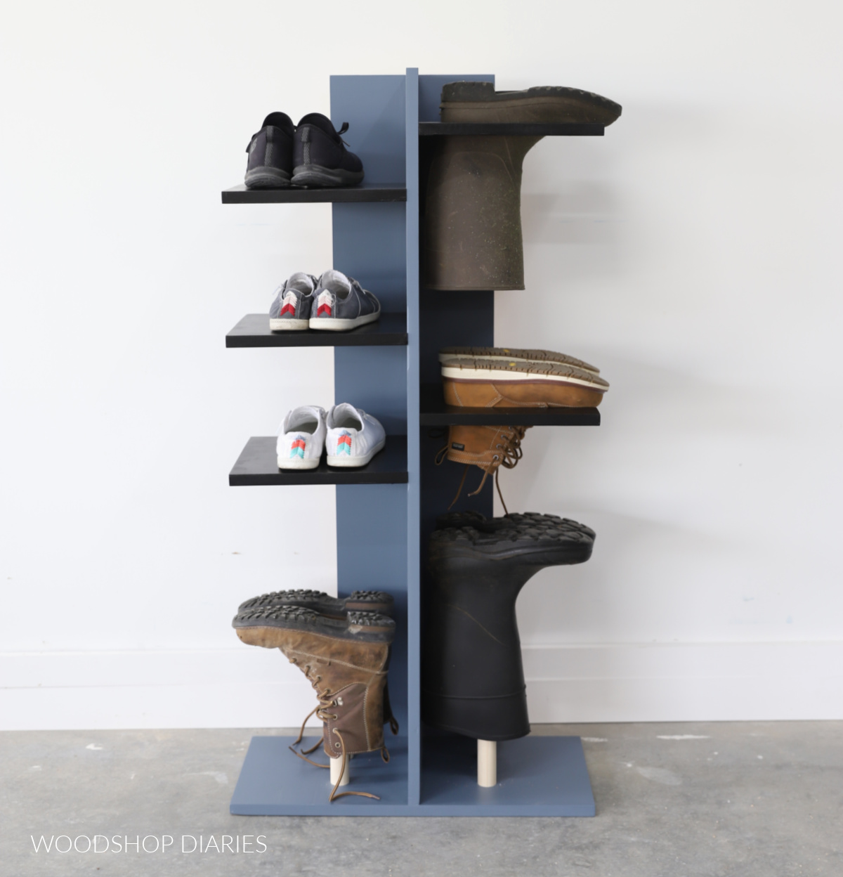 Completed shoe organizer with slotted shelves on right side and solid shelves on left side full of sneakers and boots