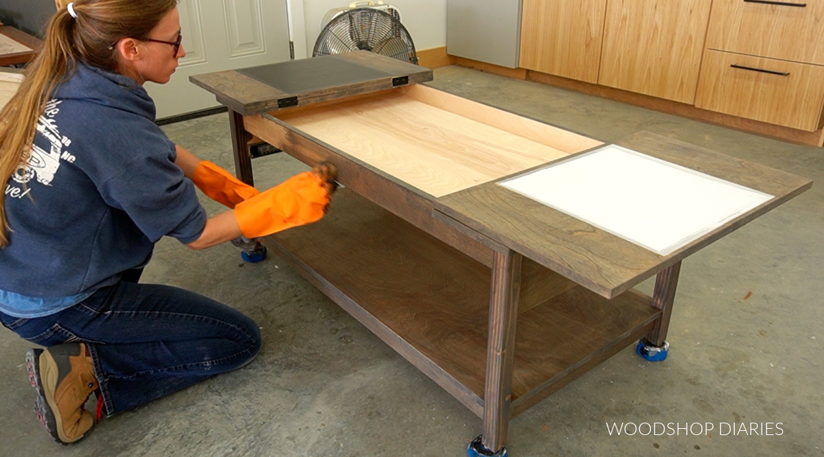 Shara Woodshop Diaries applying wood stain to puzzle coffee table