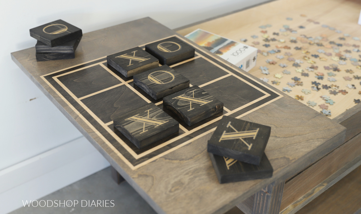 Close up of tic tac toe game pieces on flip top board game coffee table