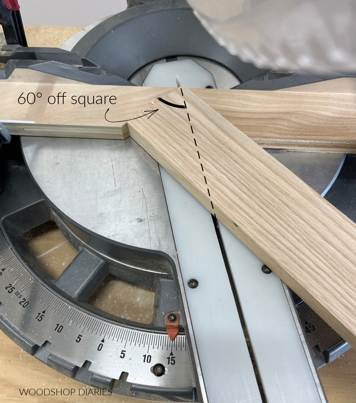 board placed in miter saw scrap blocks showing 15 degree angle setting is 60 degree cut