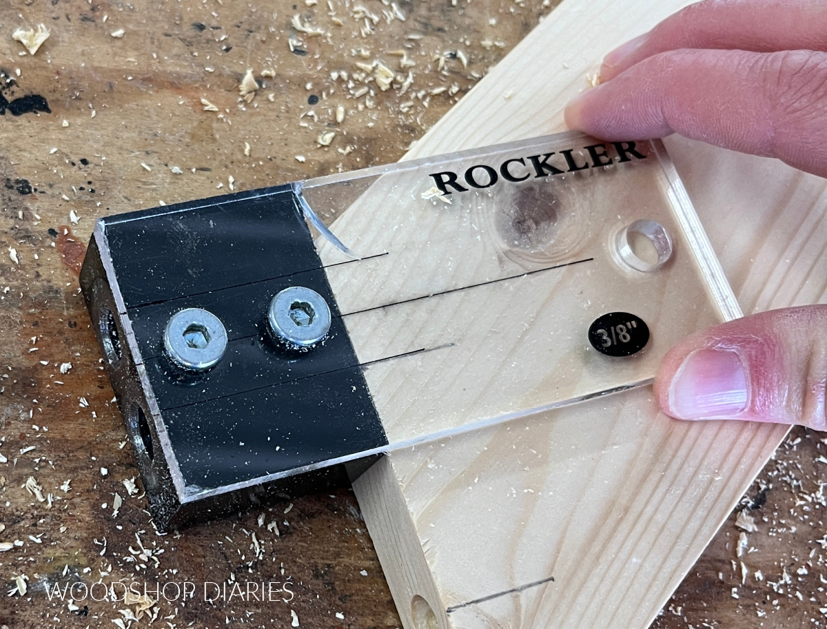 Close up of Rockler dowel jig showing centerline of jig and centerlines of dowel holes