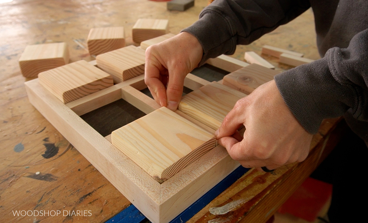 installing ½" square dowel dividers between 2x4 blocks in tray