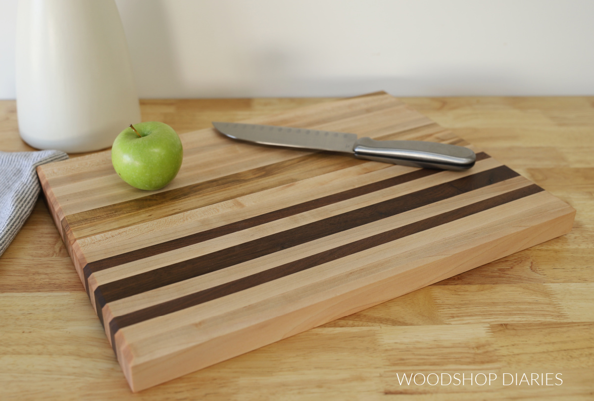 basic DIY beginner cutting board laying on butcherblock countertop with apple and knife on top