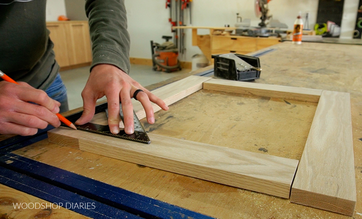 Shara Woodshop Diaries marking dowel pin location on door frame joint using a speed square