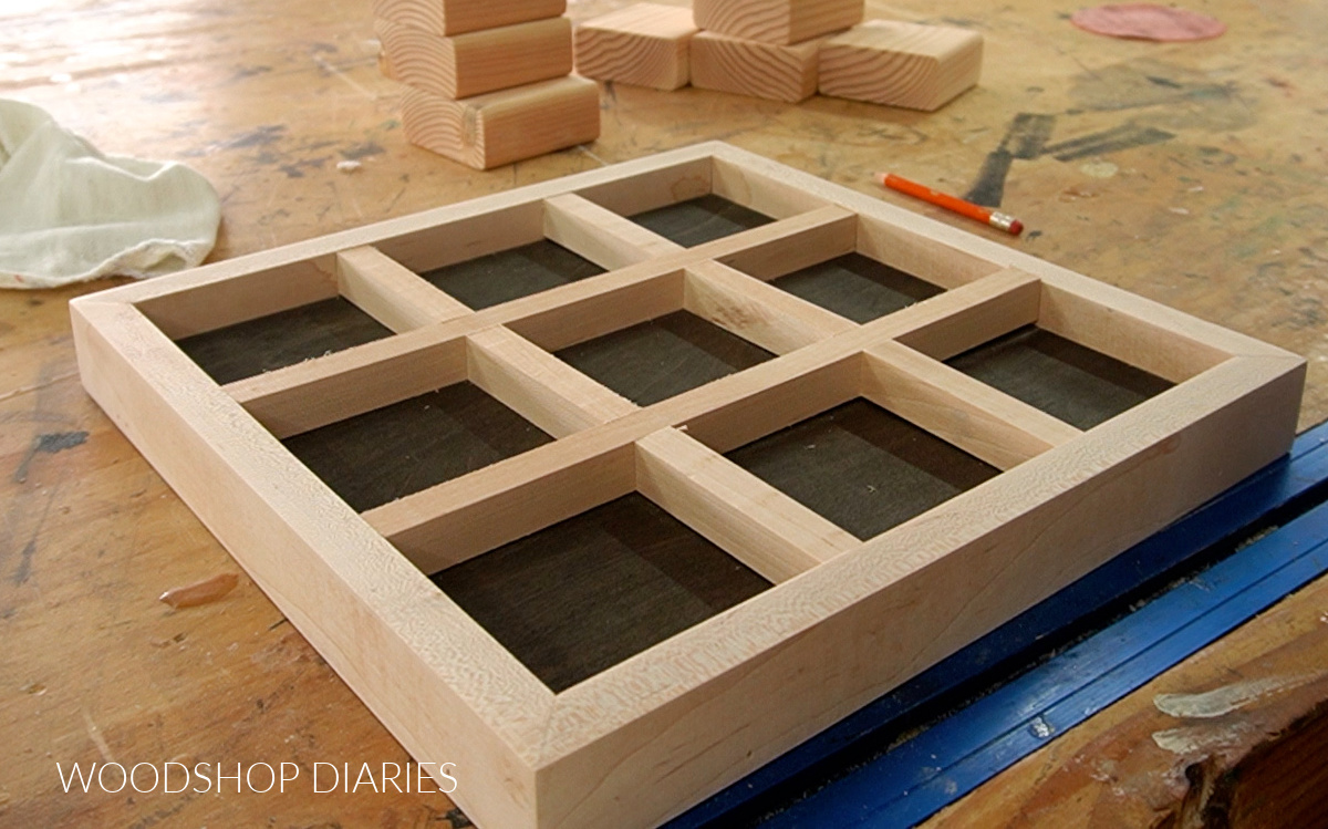 ½" square dowels glued into the tic tac toe tray on workbench