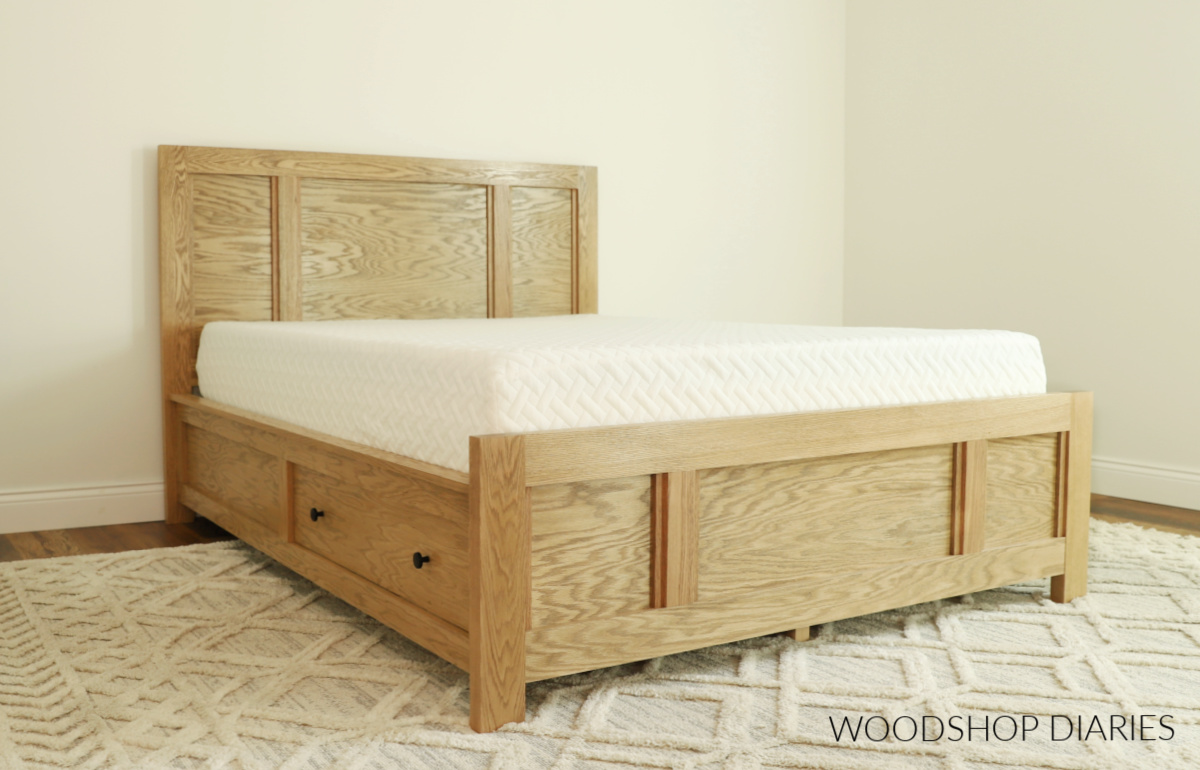 Weathered oak stained oak storage bed with built in drawers on the side panels shown assembled with mattress on top