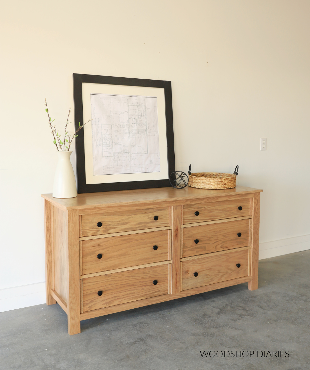 Finished 6 drawer red oak modern dresser build against white wall stained in Weathered Oak