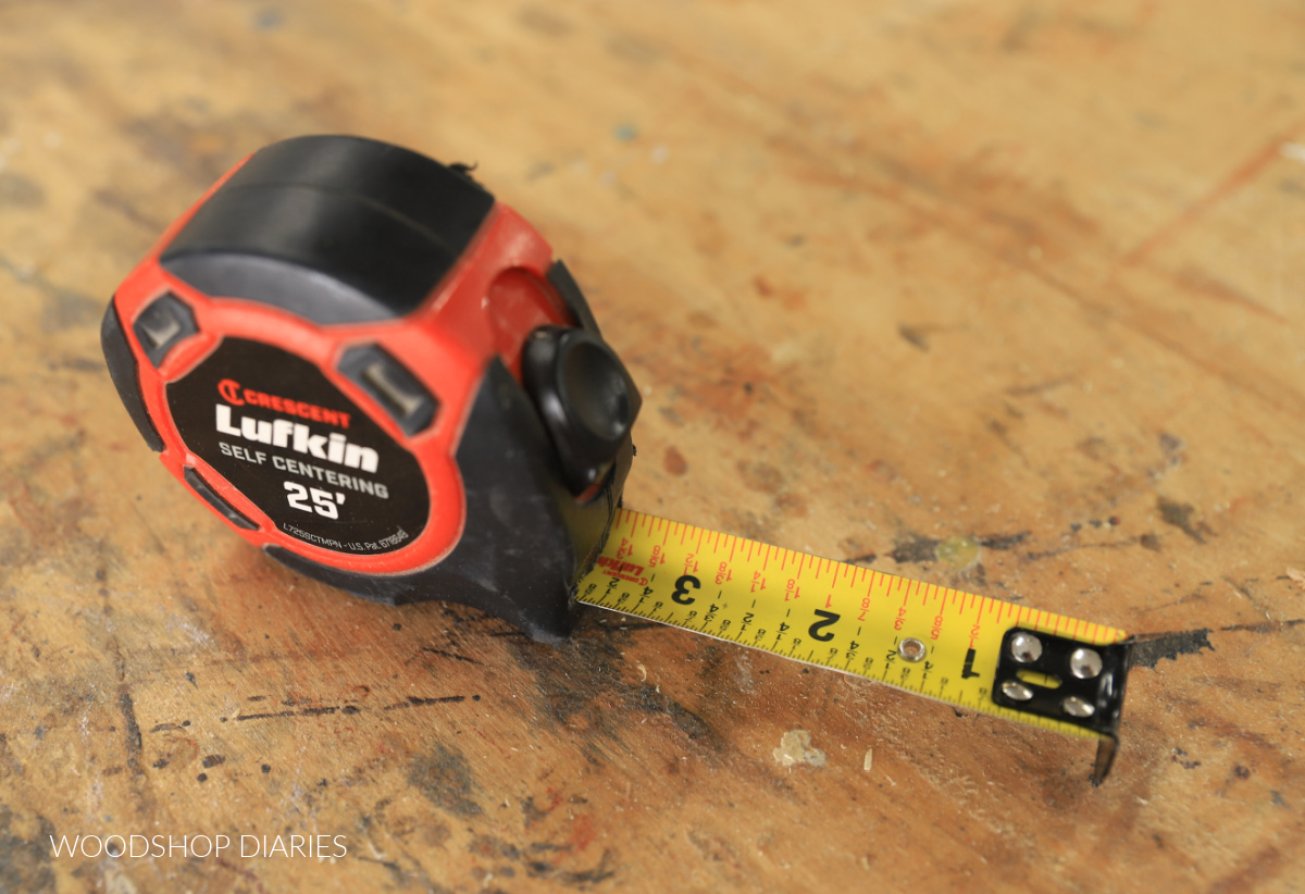 Lufkin self centering tape measure extended on workbench showing fractional labels