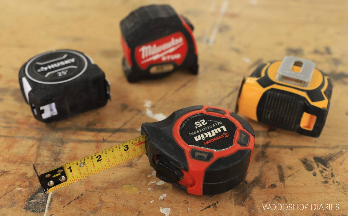 various tape measures laid out on workbench