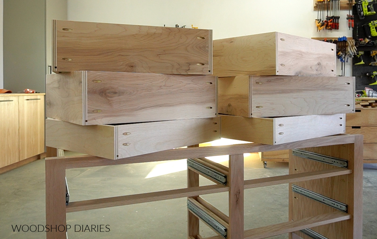 dresser drawers stacked on top of dresser frame in workshop
