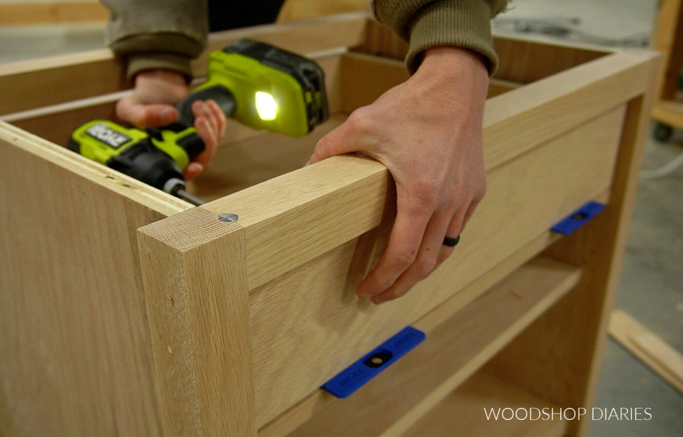 Shara Woodshop Diaries driving screws from inside drawer box to attach drawer fronts