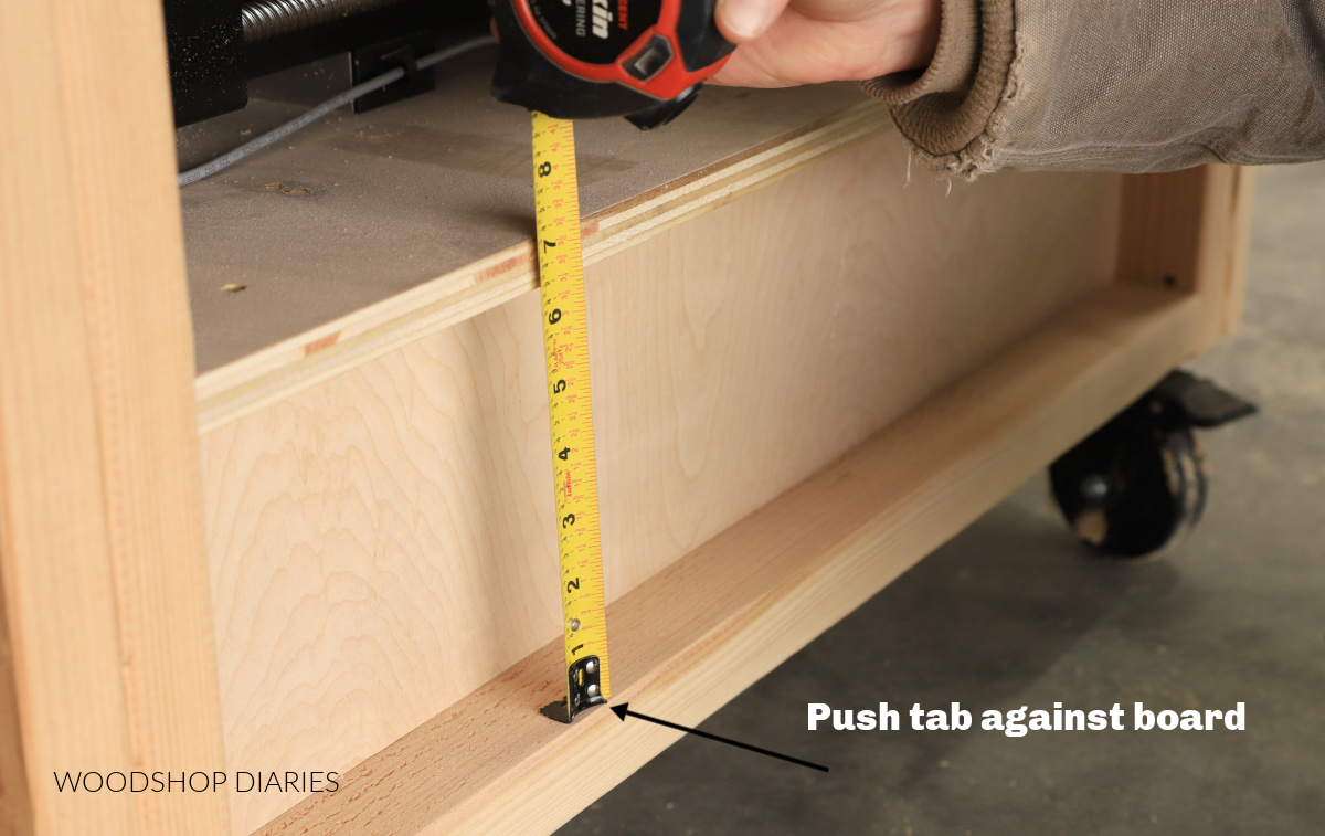 Demonstrating how to use a tape measure on the inside of a board edge