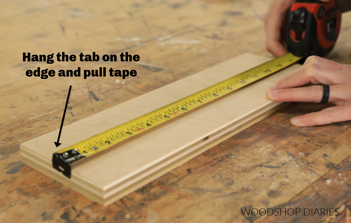 Demonstrating how to use a tape measure on the outside edge of a board