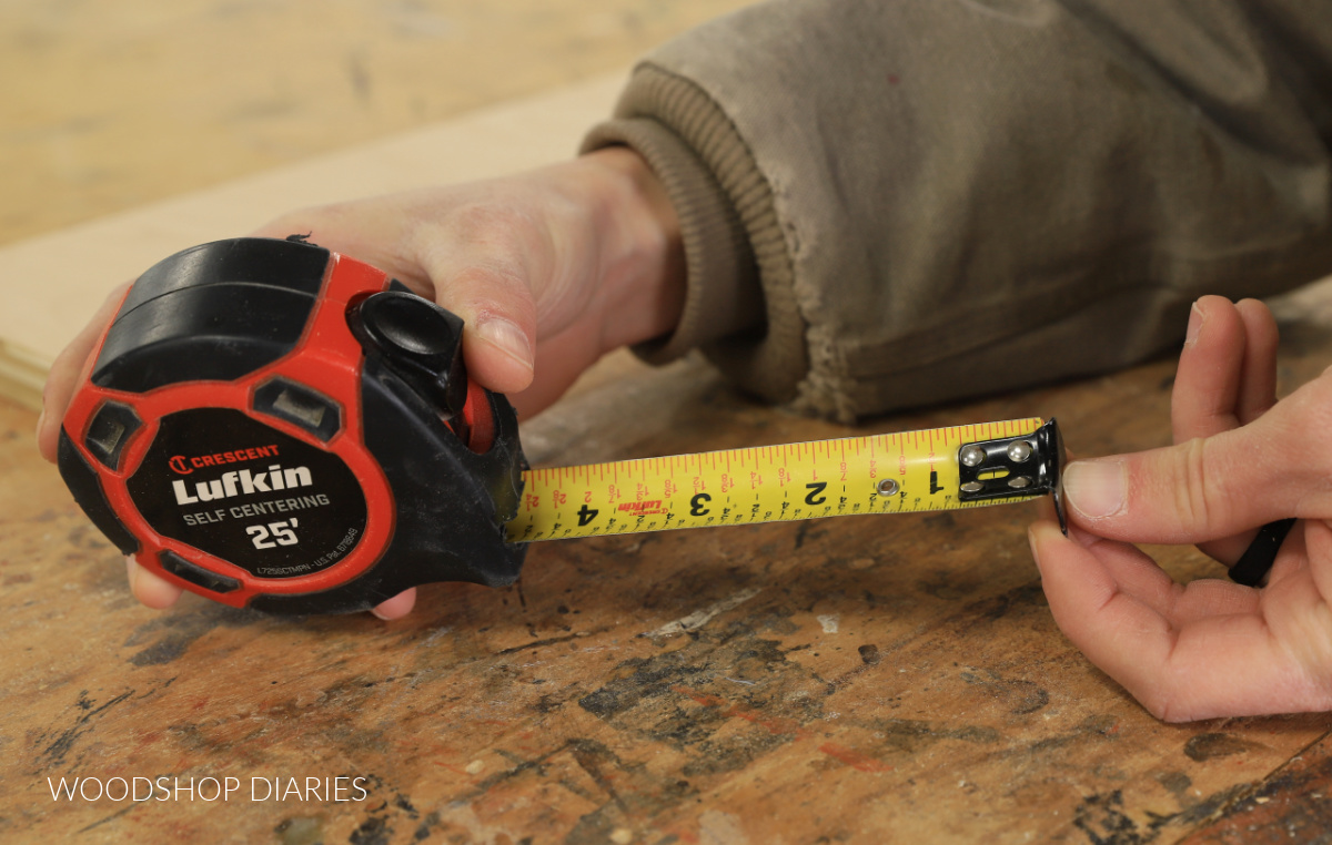 Shara Woodshop Diaries pulling tab on tape measure out of casing