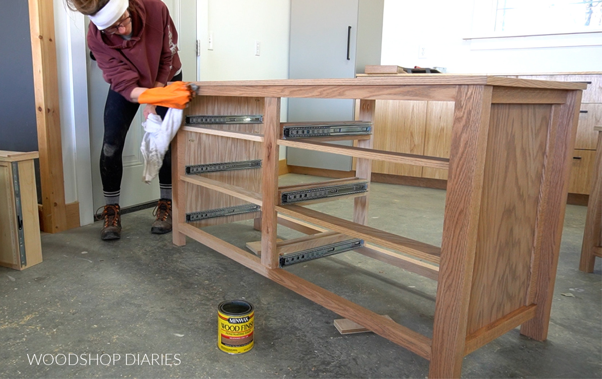 Shara Woodshop Diaries applying oil based stain to dresser frame with an old t shirt