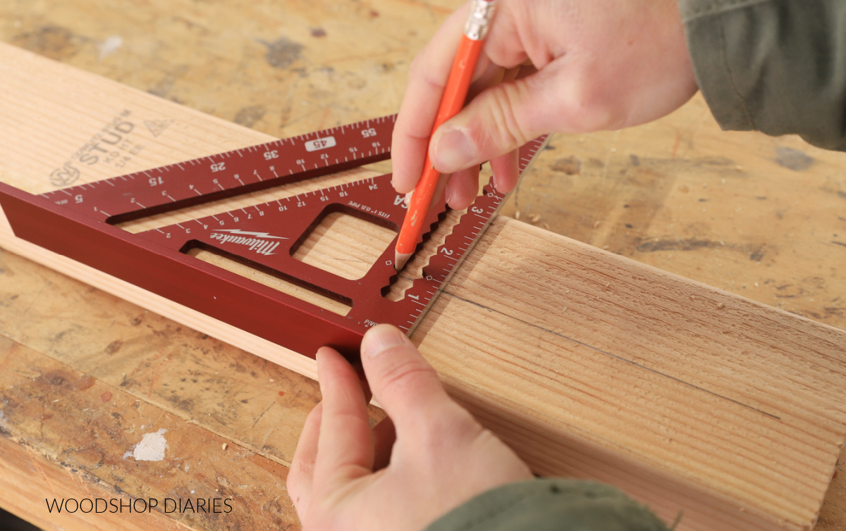 Pencil in scribe notches drawing an offset on 2x4 board