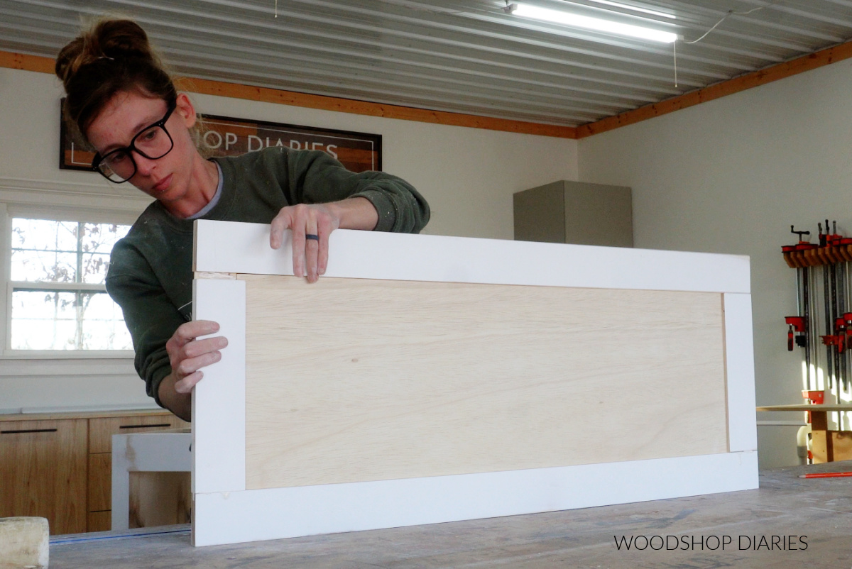 Shara Woodshop Diaries assembling cabinet door on workbench with wood glue