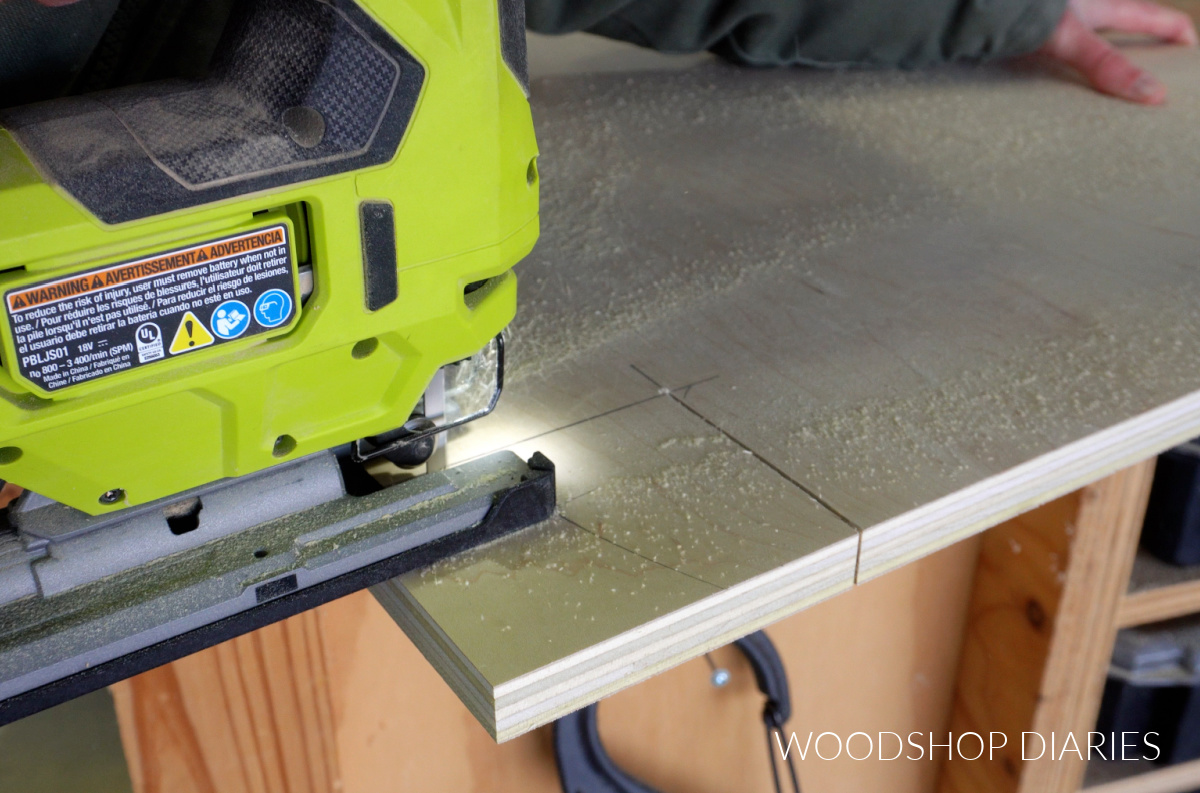 close up of jig saw cutting toe kick on base cabinet side panel