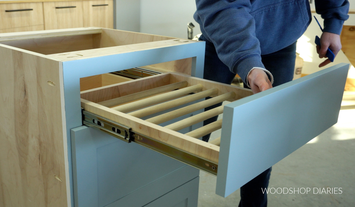 drying rack drawer installed into new base cabinet in workshop