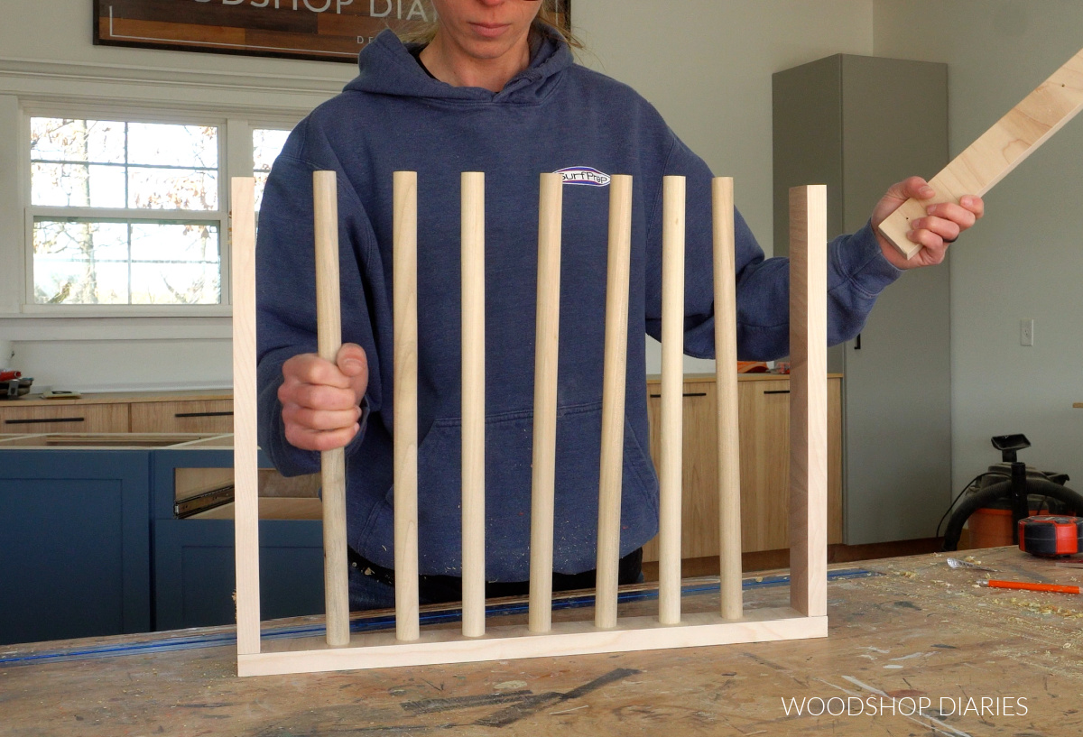 Shara Woodshop Diaries installing dowels into drying rack drawer to assemble