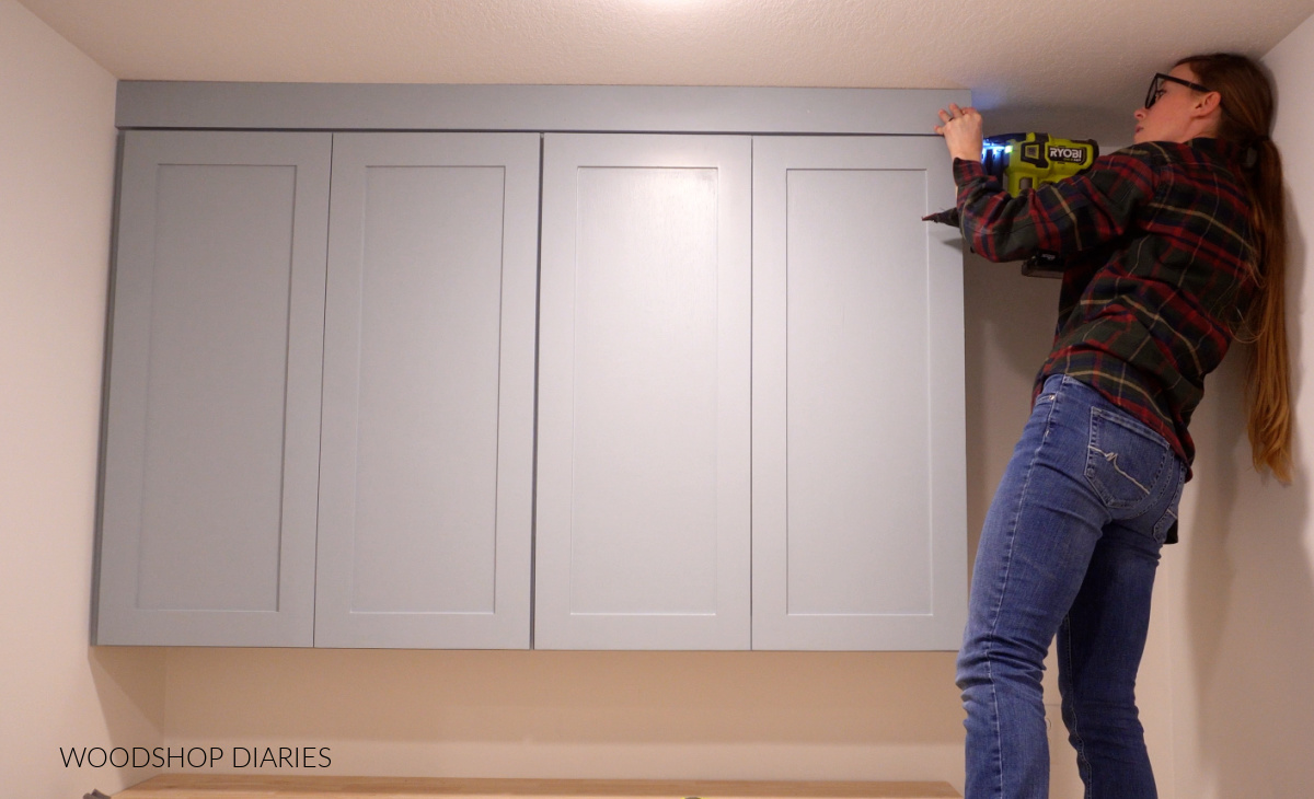 Shara Woodshop Diaries attaching trim around top of upper cabinets after installation