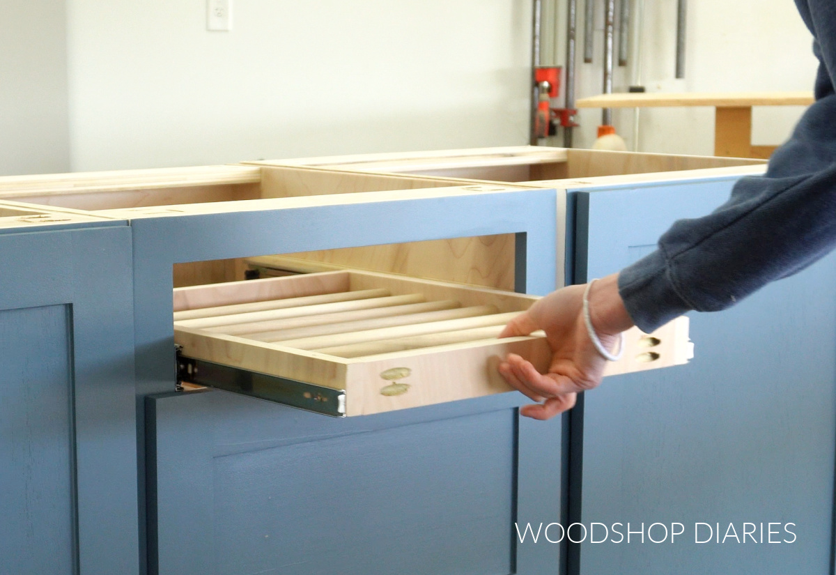 pulling drying rack drawer out of cabinet