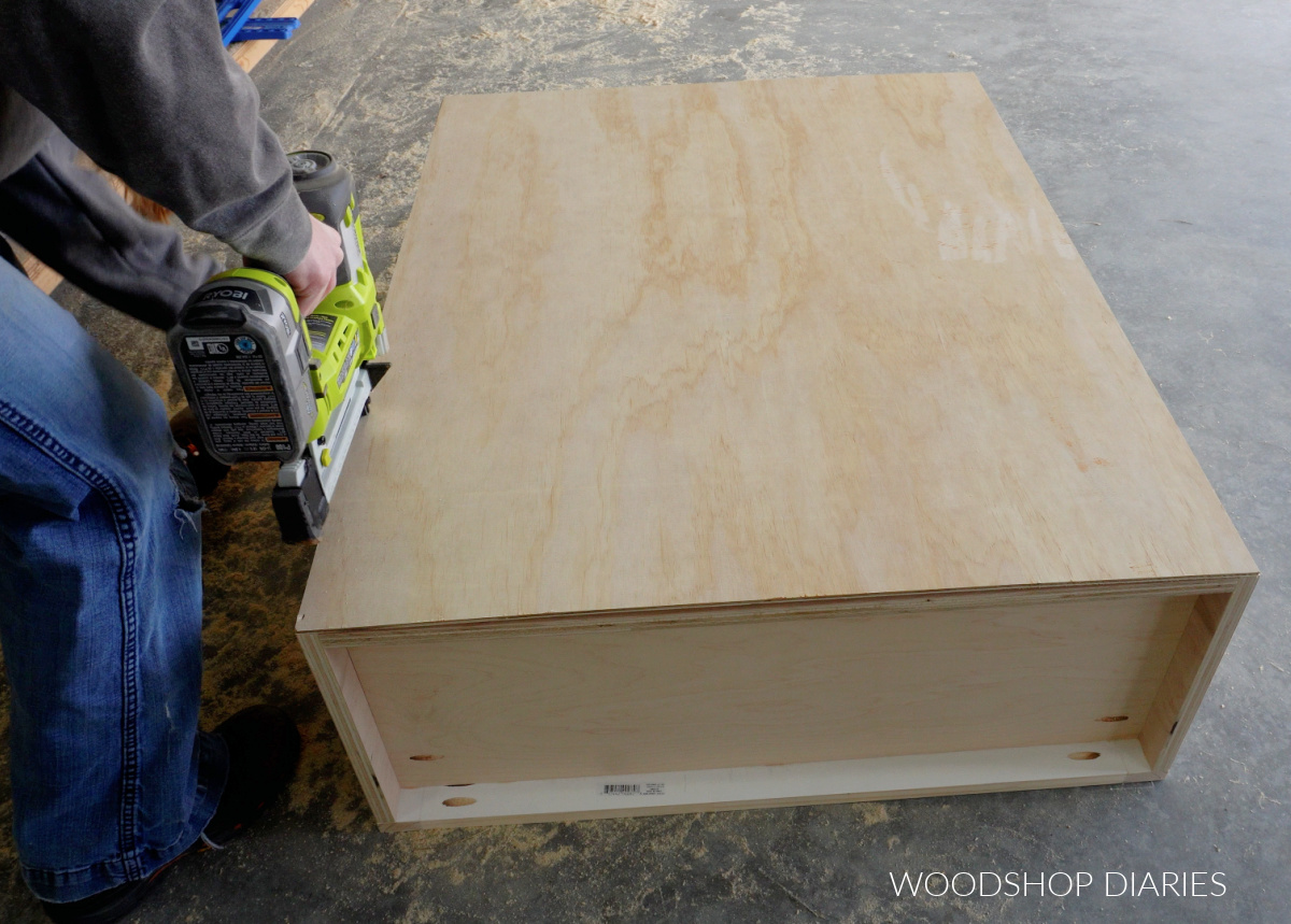 Shara Woodshop Diaries nailing back panel onto upper cabinet box